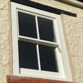 Bespoke Accoya timber box sash window with brass hardware and traditional sash horns installed at The Nest in Westbury Sub Mendip near Wells Somerset