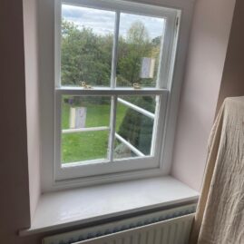 Bespoke Accoya timber box sash window with brass hardware and traditional sash horns installed at The Nest in Westbury Sub Mendip near Wells Somerset