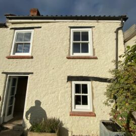 Bespoke Accoya timber box sash window with brass hardware and traditional sash horns installed at The Nest in Westbury Sub Mendip near Wells Somerset