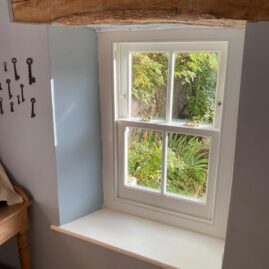 Bespoke Accoya timber box sash window with brass hardware and traditional sash horns installed at The Nest in Westbury Sub Mendip near Wells Somerset