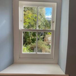 Bespoke Accoya timber box sash window with brass hardware and traditional sash horns installed at The Nest in Westbury Sub Mendip near Wells Somerset